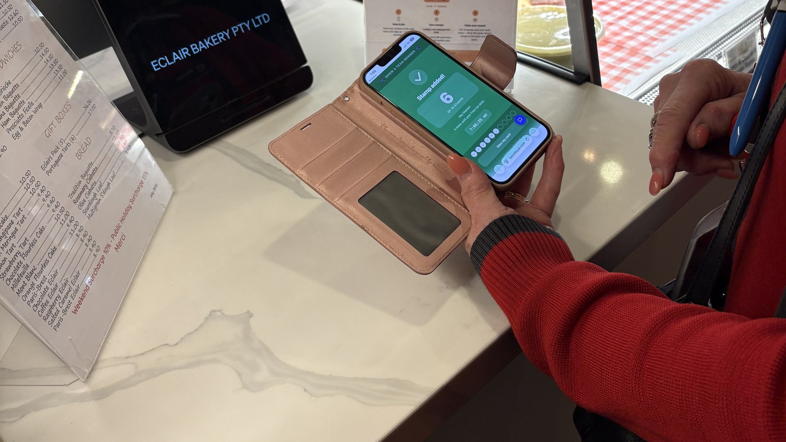 A customer scanning the Countloyal counter QR to add their own stamp at Éclair Boulangerie, Melbourne